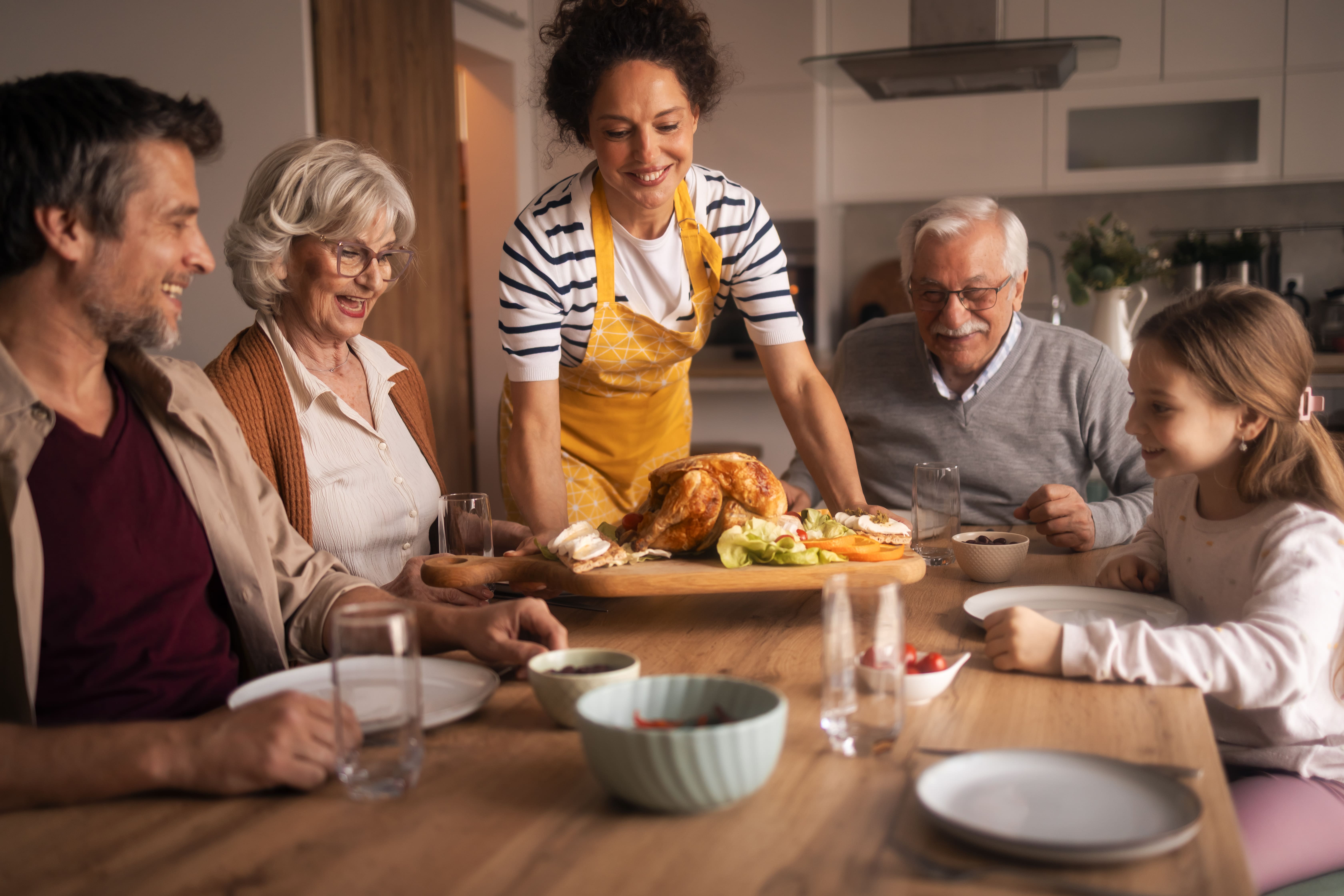Le plaisir de partager avec Ker Chant Famille partageant un repas convivial autour d'une volaille Ker Chant